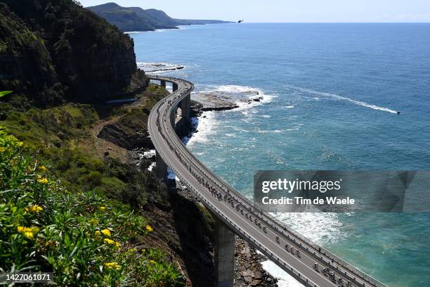 General view of the peloton passing through the Sea Cliff Bridge during the 95th UCI Road World Championships 2022, Men Elite Road Race a 266,9km...