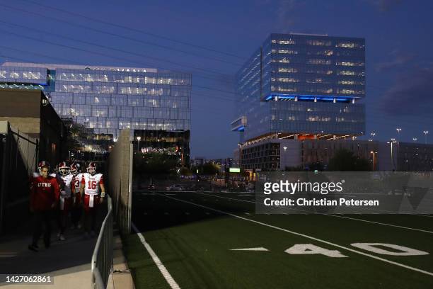 Quarterback Bryson Barnes of the Utah Utes walks out with teammates to the field before the NCAAF game against the Arizona State Sun Devils at Sun...