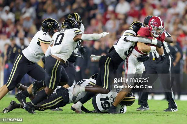 Cameron Latu of the Alabama Crimson Tide gets tackled by BJ Diakite of the Vanderbilt Commodores after a reception during the second half of the game...