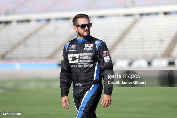 Yeley, driver of the Precision Construction & Roofing Ford, walks the grid during practice for the NASCAR Xfinity Series Andy's Frozen Custard 300 at...