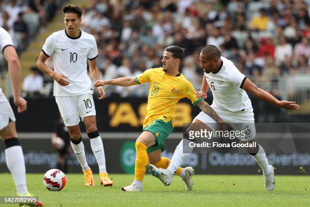 Marco Tilio of Australia kins the ball with Bill Tuiloma of New Zealand chasing during the International friendly match between the New Zealand All...