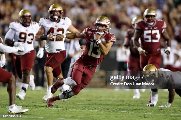 Quarterback Jordan Travis of the Florida State Seminoles runs out the pocket for additional yards during the game against the Boston College Eagles...