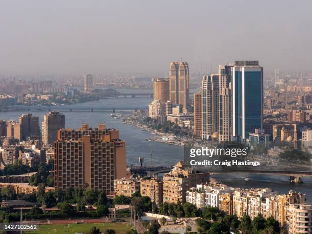 high angle view of downtown cairo during rush hour at 6 october bridge with cars in traffic jams on highways as commuters try to get home after work. - road to war in middle east and north africa stock-fotos und bilder