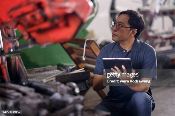 engineer inspecting wastes material in manufacturing system in industrial computer-aided manufacturing - nuclear waste management stock pictures, royalty-free photos & images