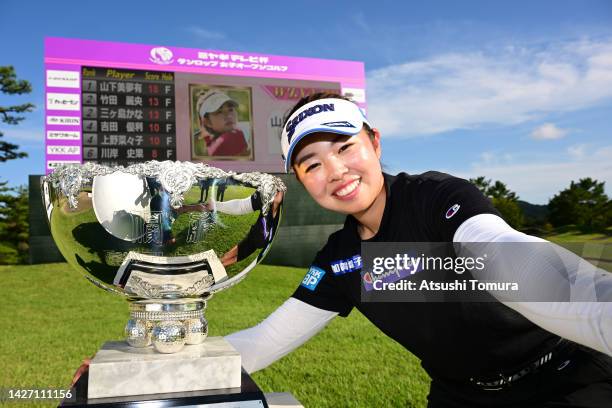 Miyuu Yamashita of Japan imitates a selfie after winning the tournament following the final round of Miyagi TV Cup Dunlop Ladies Open at Rifu Golf...