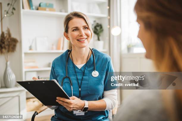 nurse in home visit for christmas - gp visit stock pictures, royalty-free photos & images