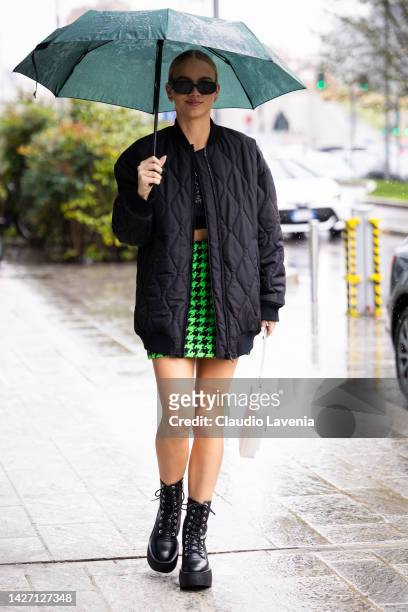 Guest is seen wearing black bomber jacket, black top and green and black skirt outside the MSGM show during the Milan Fashion Week - Womenswear...