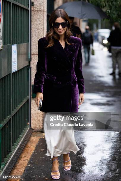 Valentina Marzullo is seen wearing a purple velvet jacket and white silk pants outside the Ermanno Scervino show during the Milan Fashion Week -...