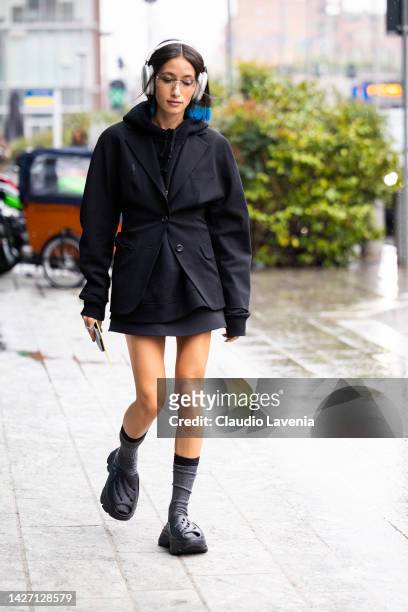 Alexandra Guerin is seen wearing Apple airpods max, a black jacket and hoodie outside the MSGM show during the Milan Fashion Week - Womenswear...