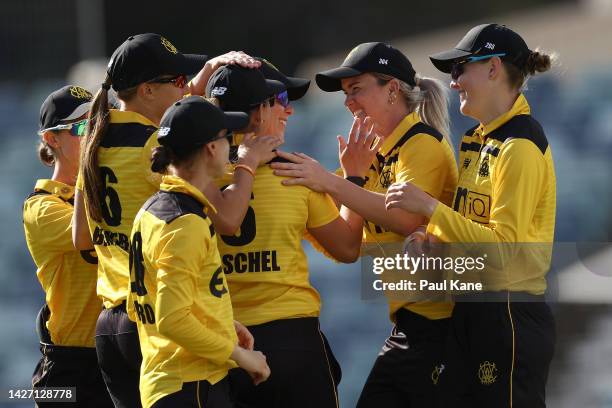 Team mates get around Taneale Peschel of Western Australia after running out Matilda Lugg of the ACT Meteors during the WNCL match between Western...