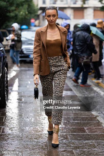 Nataly Osmann is seen wearing leopard pants, Dior bag, brown top and jacket outside the Ermanno Scervino show during the Milan Fashion Week -...