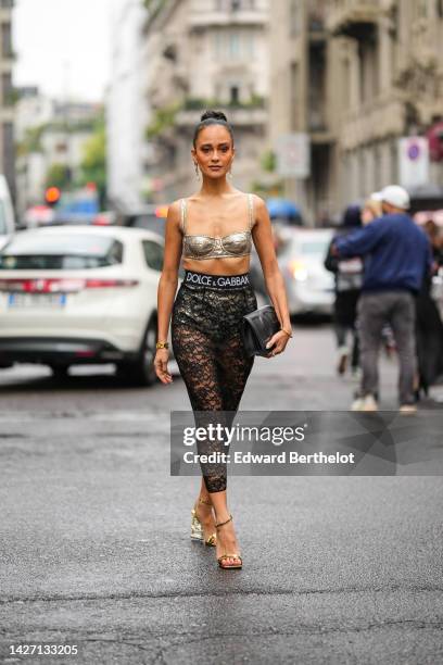 Anna Rosa Vitiello wears gold with silver rhinestones and pearls pendant earrings from Dolce & Gabbana, a gold embroidered sequined square-neck /...