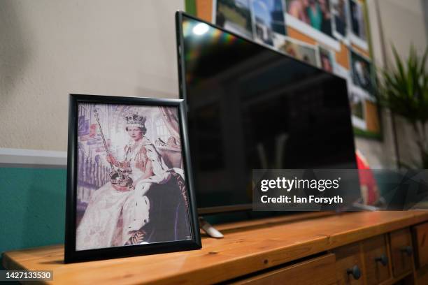 Portrait of Queen Elizabeth II is displayed at a trade stand on the first day of the Labour Party Conference in Liverpool on September 25, 2022 in...