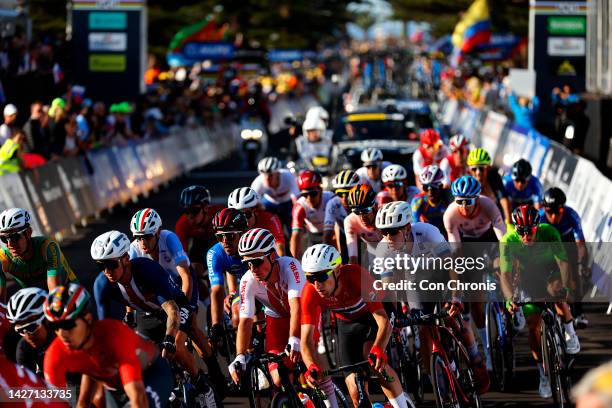 General view of the Peloton passing through the finish area while fans cheer during the 95th UCI Road World Championships 2022, Men Elite Road Race a...