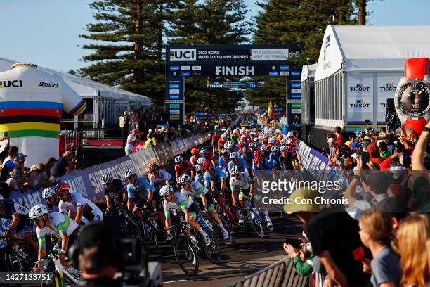 General view of the Peloton passing through the finish area while fans cheer during the 95th UCI Road World Championships 2022, Men Elite Road Race a...