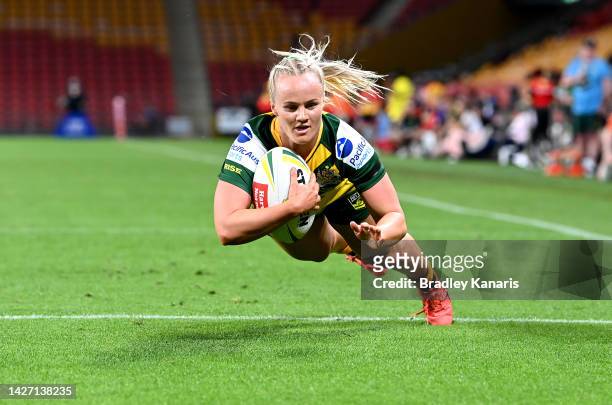 Emily Bass of Australia scores a try during the International match between the Australian Women's PMs XIII and PNG Women's PMs XIII at Suncorp...