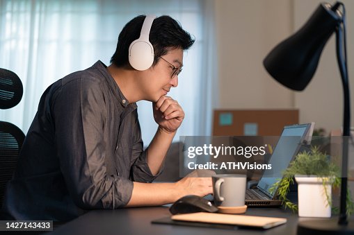 Developer Computer programmer man working Coding on laptop computer at home office. Working remotely from home Developer Computer programmer man working Coding on laptop computer at home office. Working remotely from home