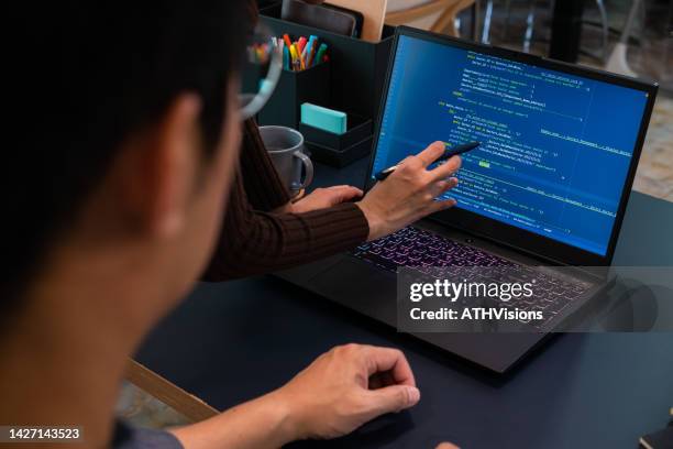 two developer computer programmer working together coding on laptop computer at home office. - pitão imagens e fotografias de stock