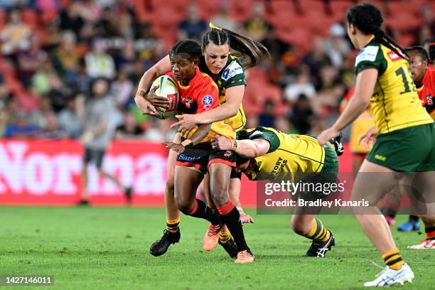 Lilah Malabag of Papua New Guinea attempts to break away from the defence during the International match between the Australian Women's PMs XIII and...