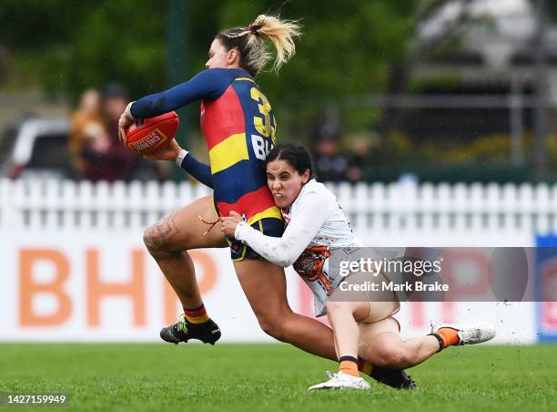 Anne Hatchard of the Crows tackled by Haneen Zreika of the Giants during the round five AFLW match between the Adelaide Crows and the Greater Western...