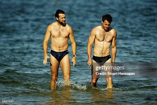 Shane Wakelin and James Clement leave the water during the Collingwood Magpies training session at St Kilda Beach, Melbourne, Australia , September...