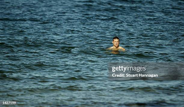 Nathan Buckley the Captain of Collingwood wades in the water during the Collingwood Magpies training session at St Kilda Beach, Melbourne, Australia...