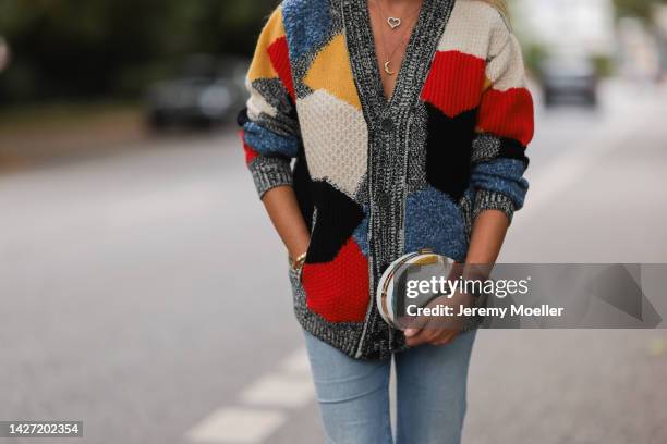 Yasmin von Schlieffen-Nannen seen wearing Chloe red gold boots, Missoni colorful knit cardigan, Frame wide leg blue jeans, Chanel matching round bag...