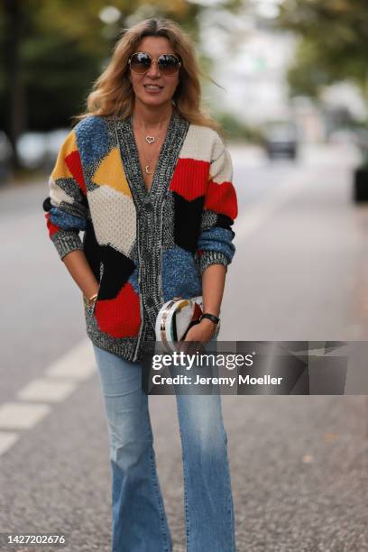 Yasmin von Schlieffen-Nannen seen wearing Chloe red gold boots, Missoni colorful knit cardigan, Frame wide leg blue jeans, Chanel matching round bag...