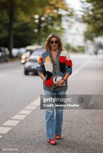 Yasmin von Schlieffen-Nannen seen wearing Chloe red gold boots, Missoni colorful knit cardigan, Frame wide leg blue jeans, Chanel matching round bag...