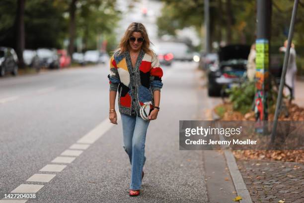 Yasmin von Schlieffen-Nannen seen wearing Chloe red gold boots, Missoni colorful knit cardigan, Frame wide leg blue jeans, Chanel matching round bag...