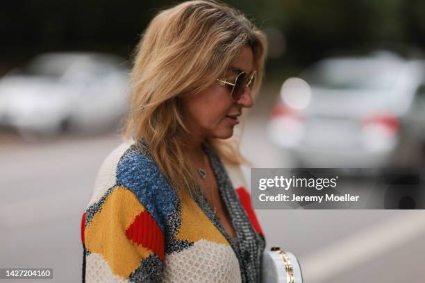 Yasmin von Schlieffen-Nannen seen wearing Chloe red gold boots, Missoni colorful knit cardigan, Frame wide leg blue jeans, Chanel matching round bag...