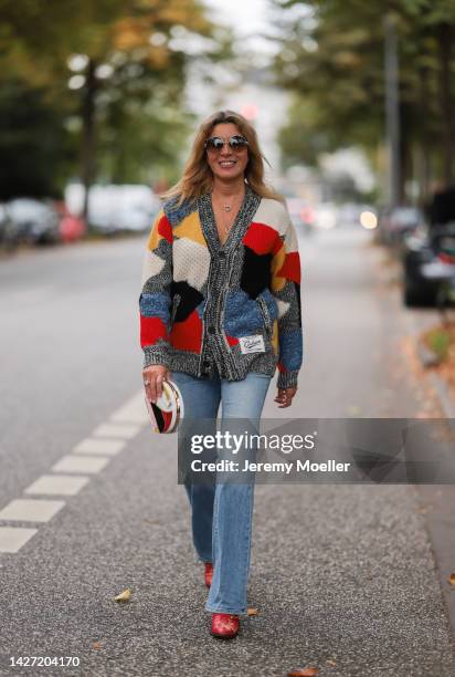 Yasmin von Schlieffen-Nannen seen wearing Chloe red gold boots, Missoni colorful knit cardigan, Frame wide leg blue jeans, Chanel matching round bag...