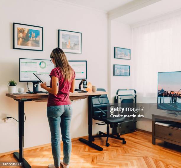 woman with diabetes working at standing desk - alexa martin stock pictures, royalty-free photos & images