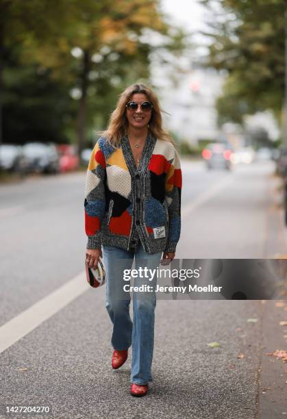 Yasmin von Schlieffen-Nannen seen wearing Chloe red gold boots, Missoni colorful knit cardigan, Frame wide leg blue jeans, Chanel matching round bag...