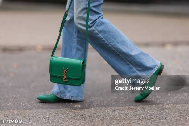 Yasmin von Schlieffen-Nannen seen wearing Golden Goose green oversized bomber jacket, Frame blue wide leg jeans, Yves Saint Laurent colorful polkadot...