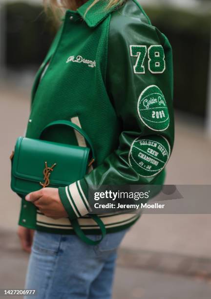 Yasmin von Schlieffen-Nannen seen wearing Golden Goose green oversized bomber jacket, Frame blue wide leg jeans, Yves Saint Laurent colorful polkadot...