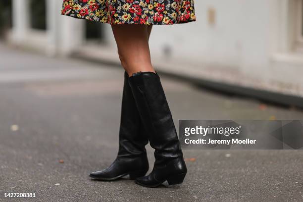 Yasmin von Schlieffen-Nannen seen wearing Isabel Marant black leather boots, Isabel Marant checked brown beige hat and Ganni mini colorful flower...