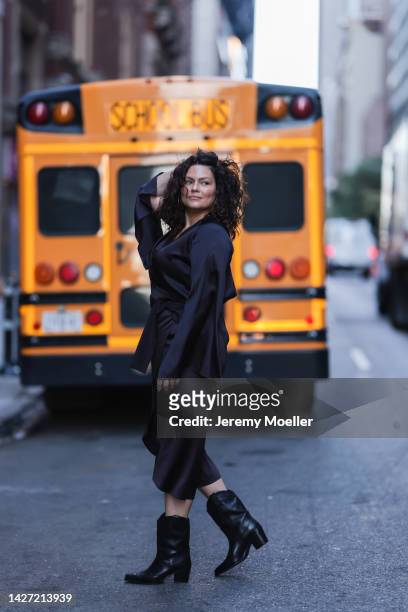 Dayami Candebat is seen wearing a black satin kimono long dress from LeManjá Berlin and black leather cowboy boots from H&M, during New Yorker...