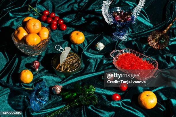 xmas modern dinner table setting on green velvet fabric background. creative merry christmas celebration concept. contemporary new year festive backdrop - christmas still life stock-fotos und bilder