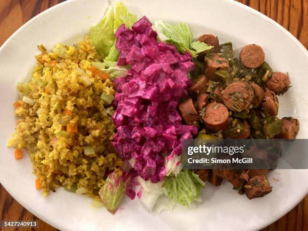 vegan lunch plate of vegetable rice, beetroot salad, and vegan sausage with green bell peppers - tampico stock pictures, royalty-free photos & images