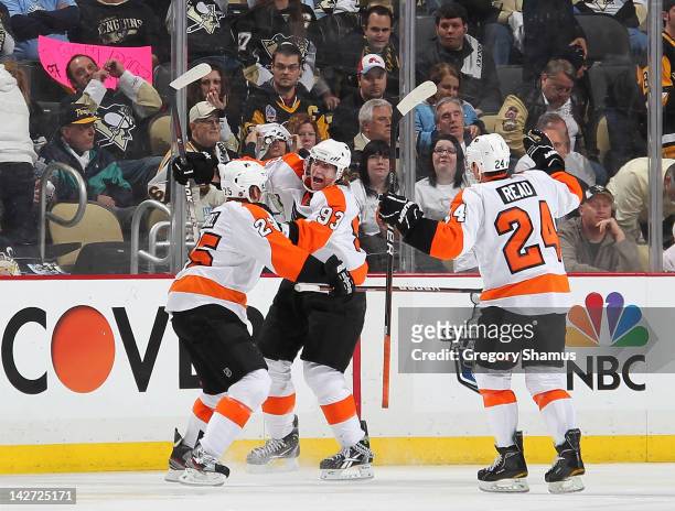 Jakub Voracek of the Philadelphia Flyers celebrates his game winning goal with Matt Carle and Matt Read against the Pittsburgh Penguins in Game One...