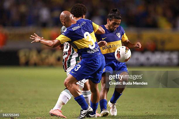 Wellinton Nem of Fluminense struggle for the ball with Clemente Rodriguez and Walter Erviti of Boca Juniors during a match between Fluminense and...