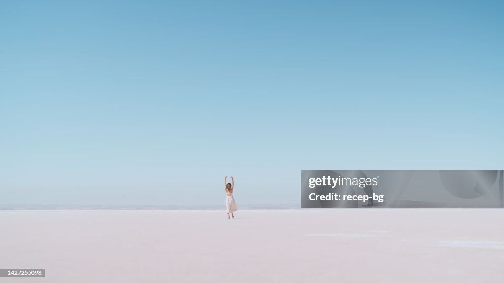 Young female tourist walking on white salt in Salt Lake Türkiye
