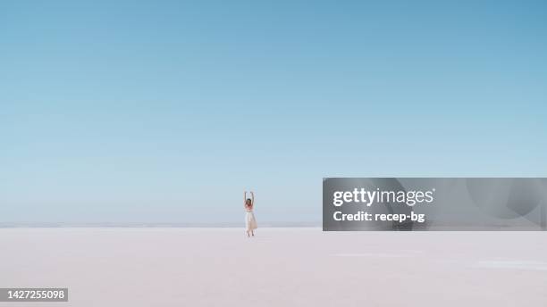 young female tourist walking on white salt in salt lake türkiye - anadolu stock pictures, royalty-free photos & images