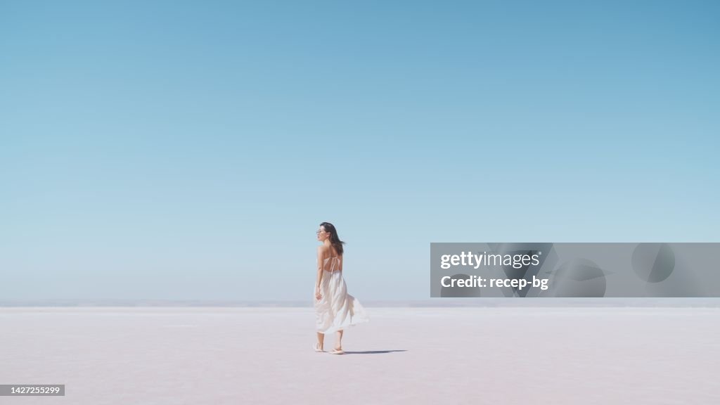 Young female tourist walking on white salt in Salt Lake Türkiye