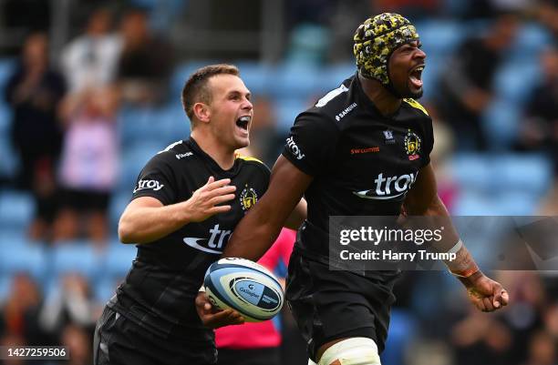 Christ Tshiunza of Exeter Chiefs celebrates their sides third try with team mate Joe Simmonds during the Gallagher Premiership Rugby match between...