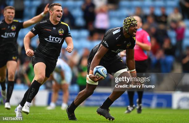 Christ Tshiunza of Exeter Chiefs celebrates their sides third try with team mate Joe Simmonds during the Gallagher Premiership Rugby match between...