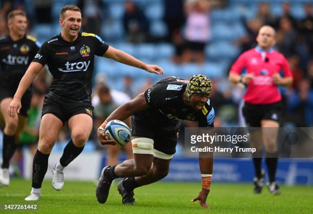 Christ Tshiunza of Exeter Chiefs celebrates their sides third try with team mate Joe Simmonds during the Gallagher Premiership Rugby match between...