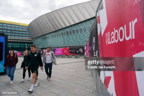 People walk along the outside of the perimeter fence on the first day of the Labour Party Conference in Liverpool on September 25, 2022 in Liverpool,...