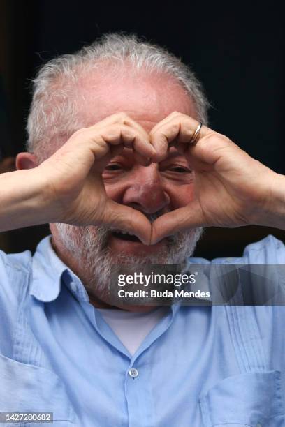 Brazil's former president and current presidential candidate Luiz Inacio Lula da Silva greets to supporters during a campaign rally in the final week...